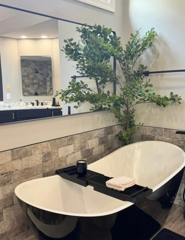 Black freestanding soaking tub with floor-mounted tub filler