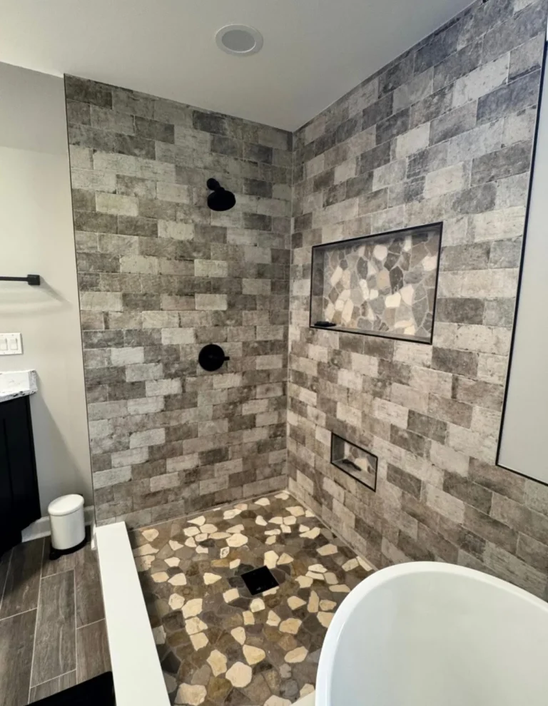 Close-up of brick-look shower tile with mosaic accent niche
