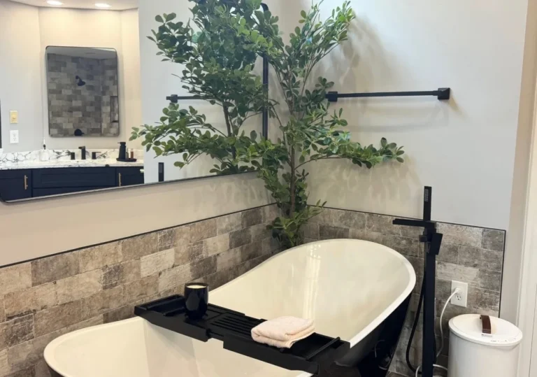 Freestanding tub with matte black floor-mount tub filler