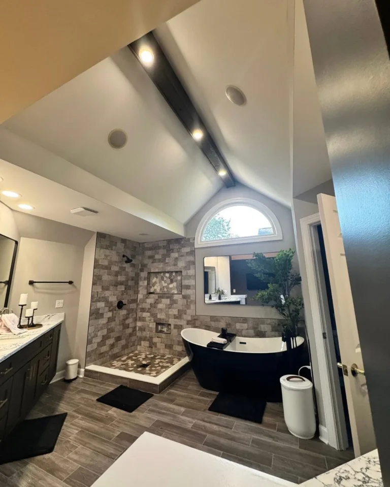 Master bathroom remodel under a vaulted ceiling with wood beam