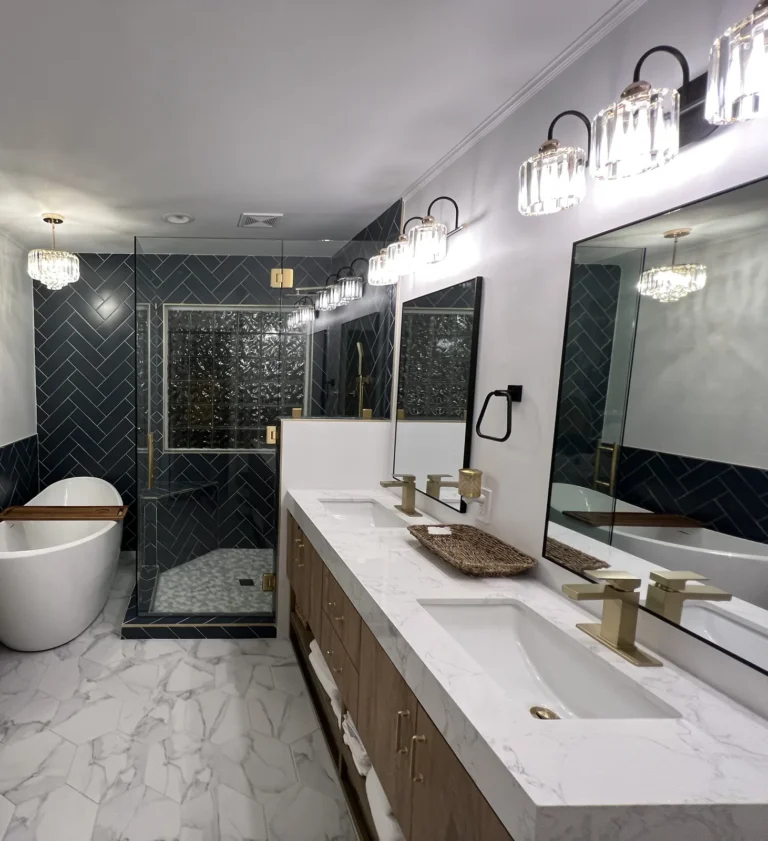 Bathroom remodel with navy herringbone tile, freestanding tub and gold fixtures, Charlotte area