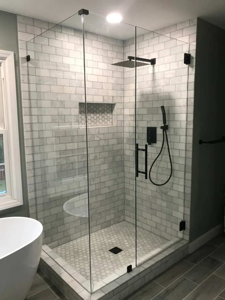 White marble subway tile shower with matte black fixtures