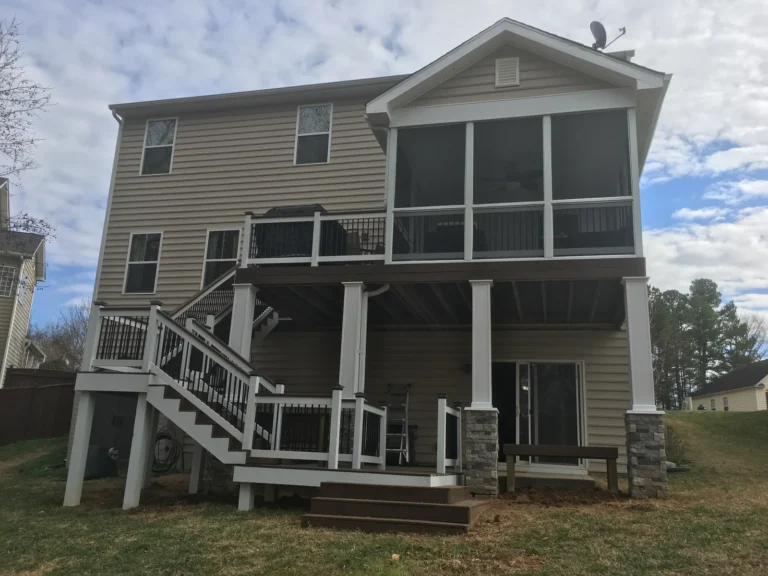 Finished two-level composite deck with screened porch and stone-base columns