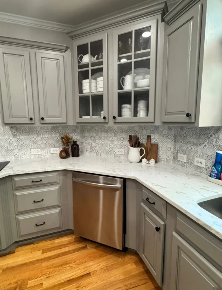 After: gray cabinets with glass doors and quartz counters