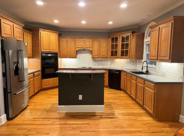 Before: kitchen with honey oak cabinets and a dark island