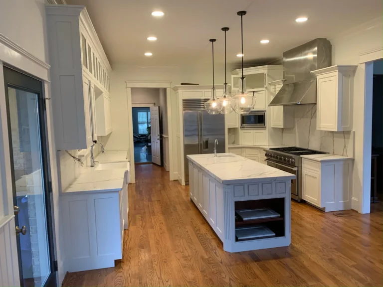 After: white painted kitchen with pendant lights