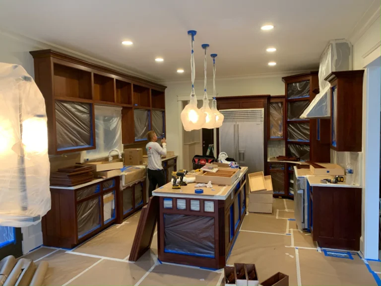During: dark cherry cabinets masked for painting white