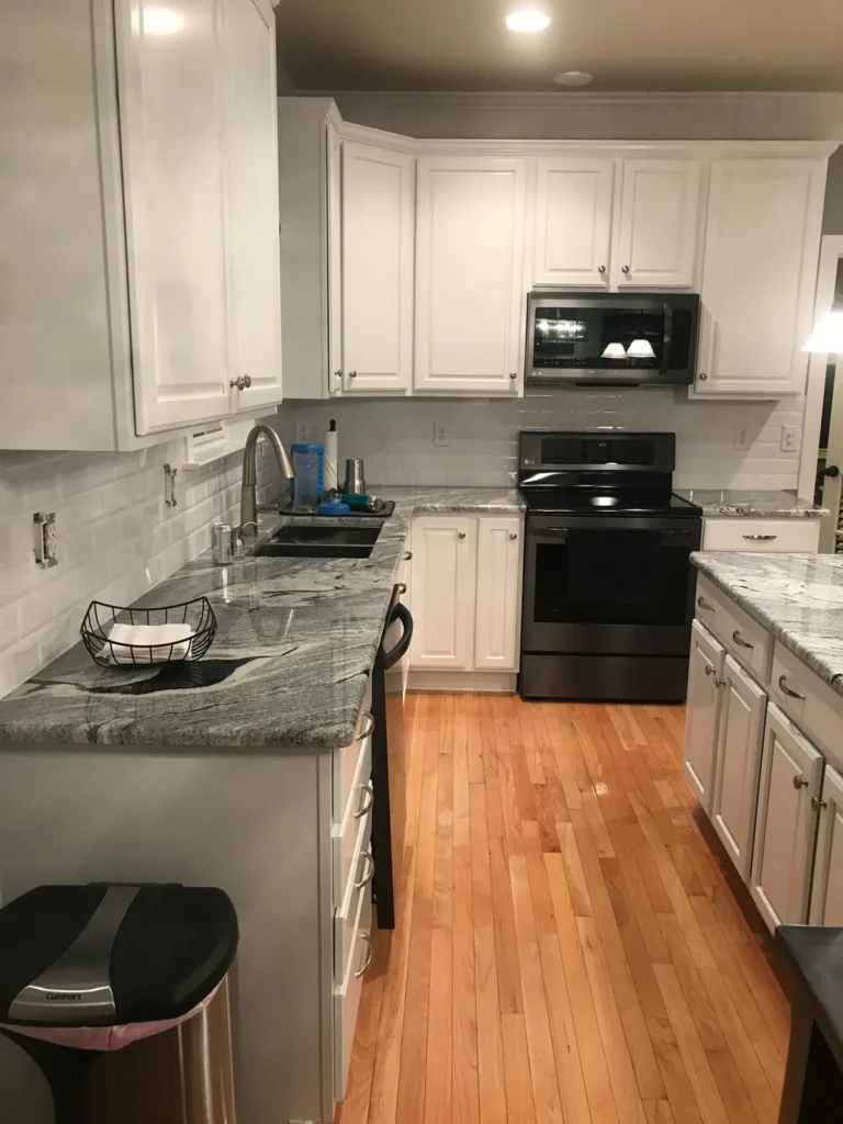 After: maple cabinets painted white with granite counters