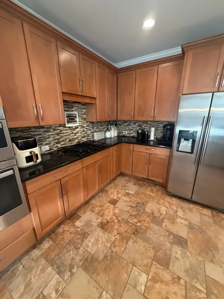 Kitchen with maple cabinets and black granite counters